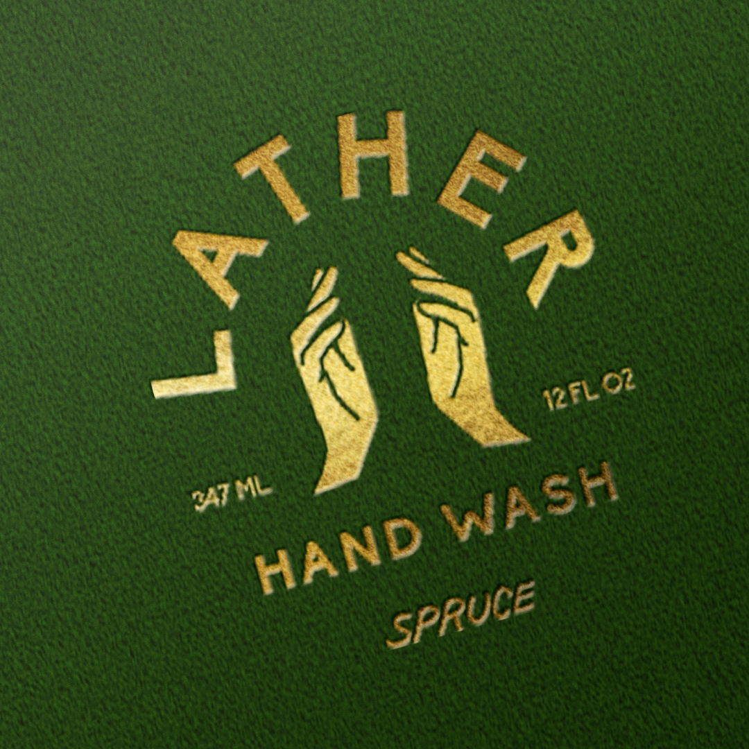 Packaging with gold foiled text and illustrations for a hand wash brand named Lather.